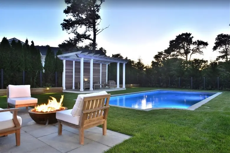 Backyard firepit, pool and pergola at a Nantucket modular home
